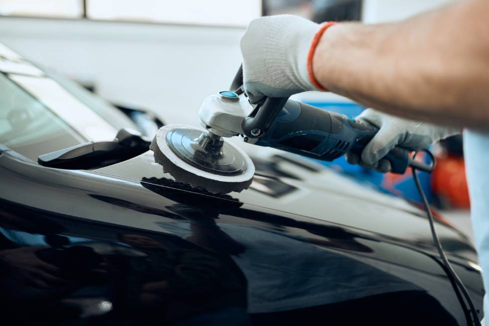 a person is polishing the car