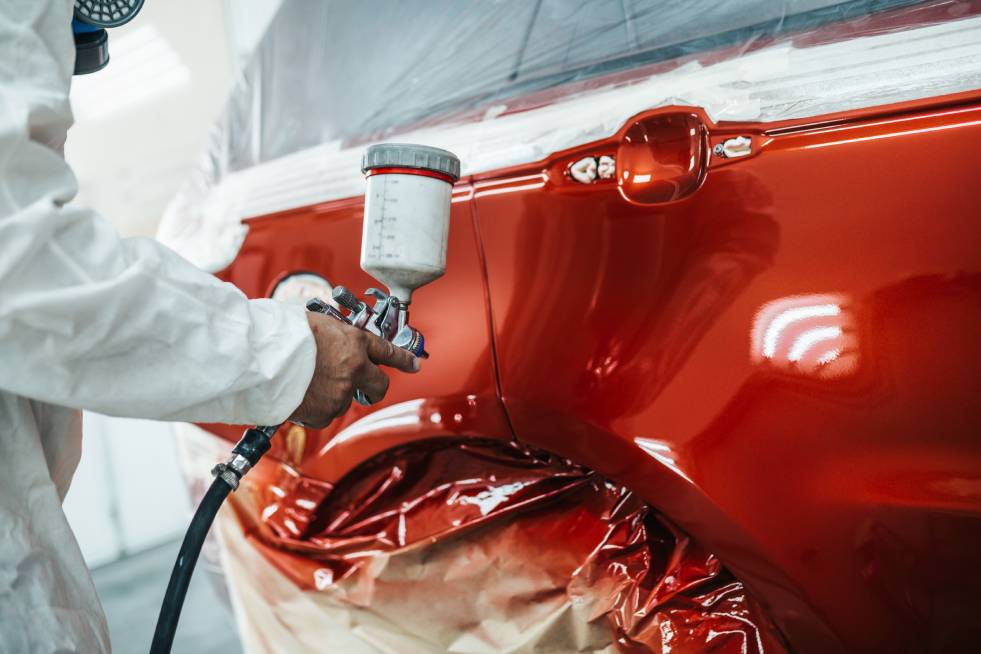  a professional is painting the car